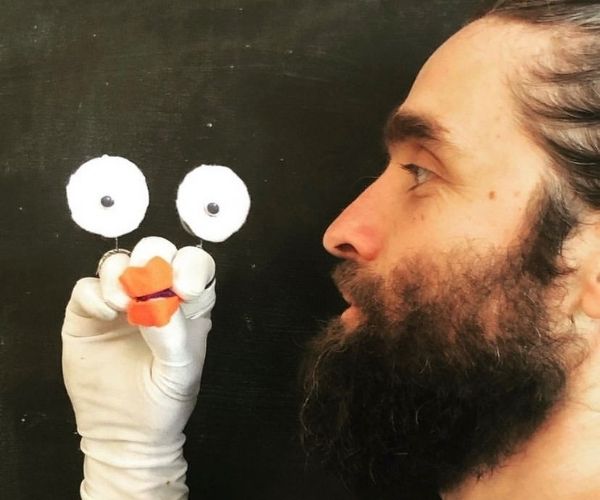 A storytelling man with hand puppet, Paul Crebar