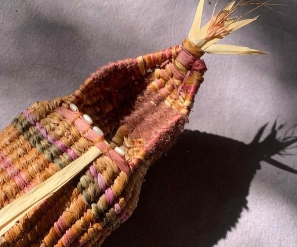 A woven basket in a gallery setting